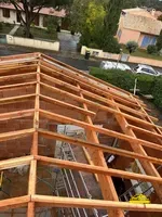 Installation d'une charpente en bois robuste sur une maison neuve.